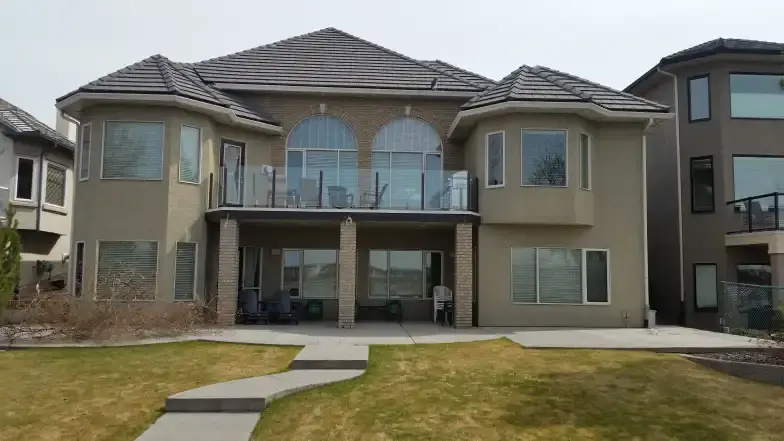 Home with arched upper windows and lower-level windows